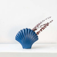 Rust brown dried eucalyptus stem styled in a warm modern room adding rustic natural texture to contemporary home decor.
