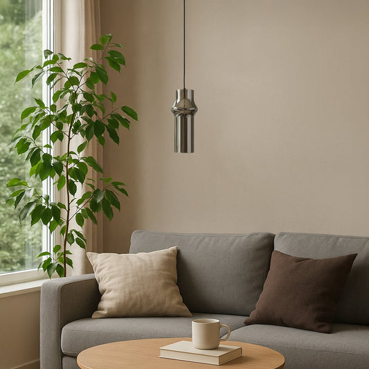 Chrome pendant light hanging elegantly above a cozy living room adding a modern metallic touch to interiors.