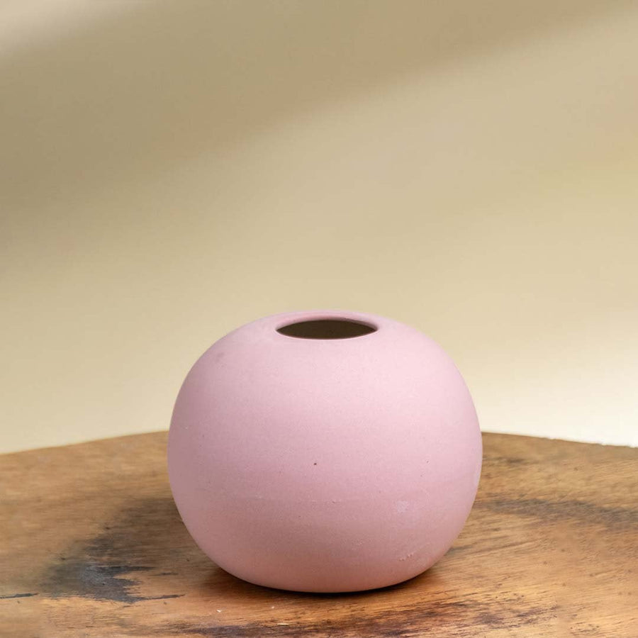 Minimal pink ceramic sphere vase with smooth matte texture shown on a white background perfect for tabletop and shelf decor.