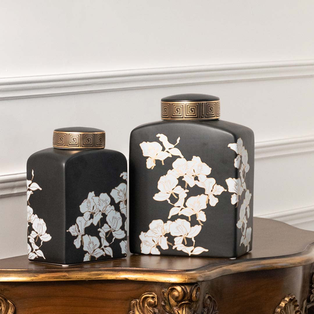 Set of black ceramic decorative jars with white floral artwork for luxury shelf styling and modern home decor.