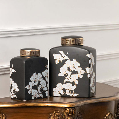 Set of black ceramic decorative jars with white floral artwork for luxury shelf styling and modern home decor.