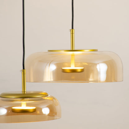 Amber glass pendant light closeup showcasing tinted glass finish and refined modern lighting craftsmanship details.