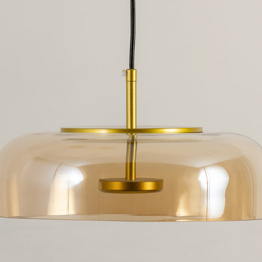 Gold metal pendant light with wide dome shade and sleek design ideal for modern kitchen island or dining decor placement.