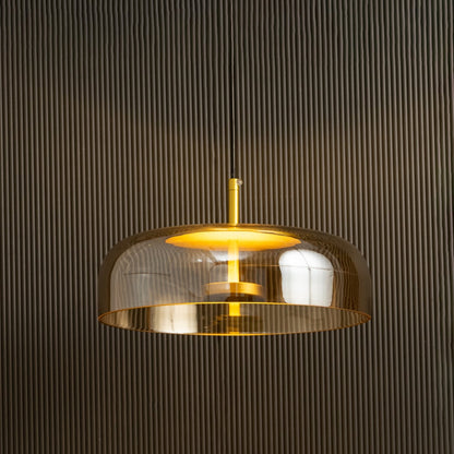 Amber glass pendant light with metal detailing casting a warm ambient glow imagined against a dark background creating a dramatic modern interior decor mood.