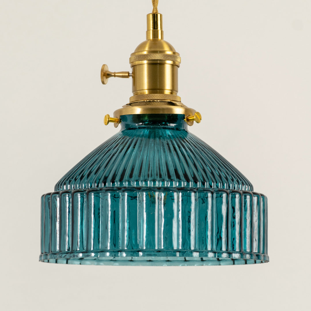 Modern blue glass pendant light with gold metal accents for stylish kitchen and dining room decor styling.