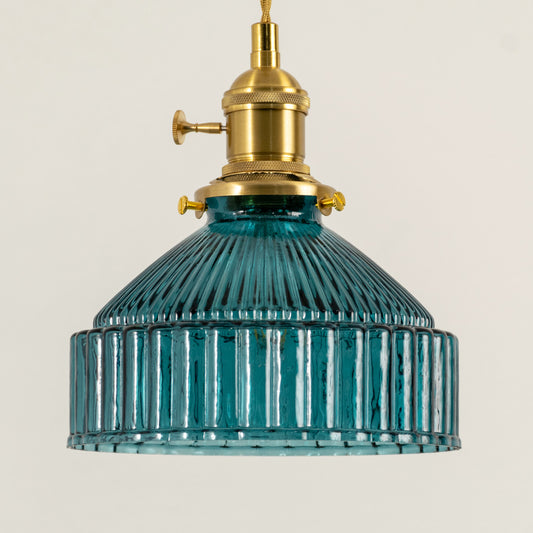 Modern blue glass pendant light with gold metal accents for stylish kitchen and dining room decor styling.