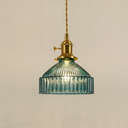 Gold metal pendant light with blue ribbed glass shade illuminated to highlight elegant decorative ceiling lighting.