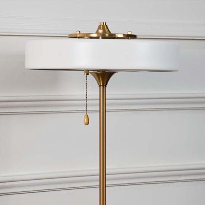 White metal table lamp top showcasing refined craftsmanship with pull chain detail and elegant modern design accents.