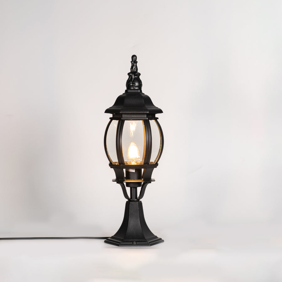 Vintage black outdoor gate light with warm glowing bulb for elegant exterior decor styling use.