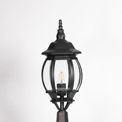 Closeup of decorative outdoor black pillar light with clear curved glass and LED bulb highlighting premium classic design.