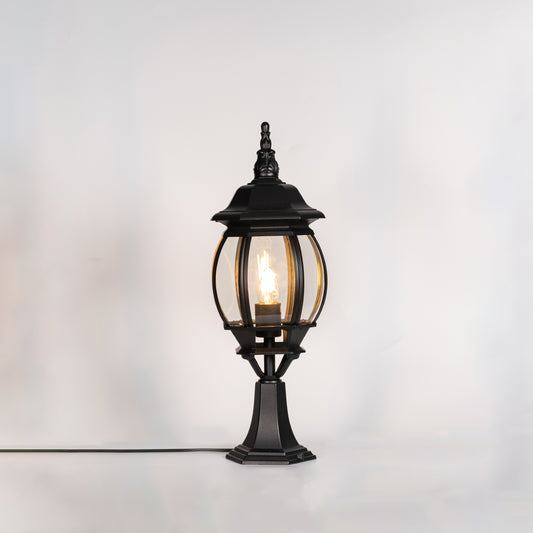 Classic black outdoor gate light with warm glowing bulb for stylish exterior decor styling use.