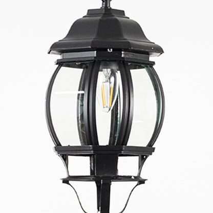 Closeup view of outdoor hanging lantern light showing bulb detail and smooth black metal design.