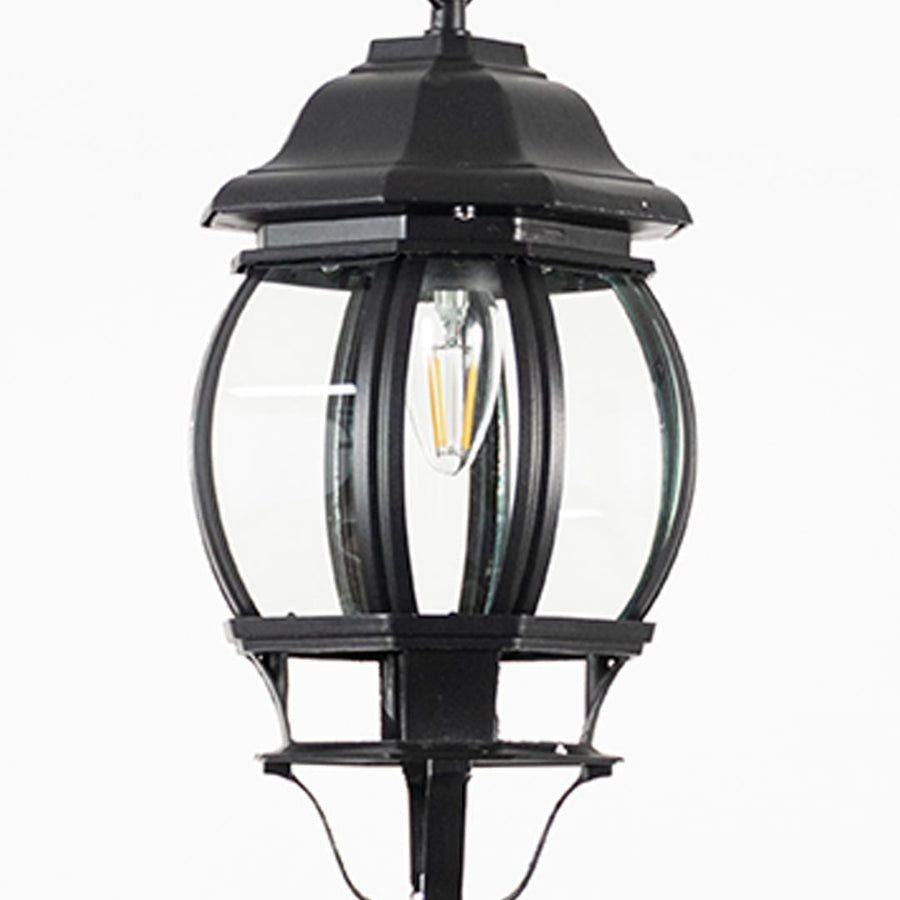 Closeup view of outdoor hanging lantern light showing bulb detail and smooth black metal design.