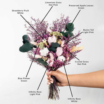 Decorative dried flower bouquet with infinity rose crystal grass limonium grass bunny tail strawberry fruit and apple leaves.