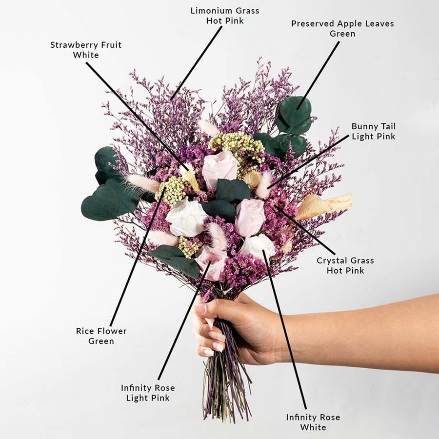 Decorative dried flower bouquet with infinity rose crystal grass limonium grass bunny tail strawberry fruit and apple leaves.