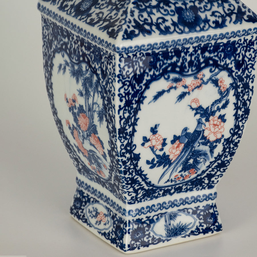 Closeup of blue ceramic decor vase with intricate pattern detailing perfect for elegant table or shelf decor styling in home interior.