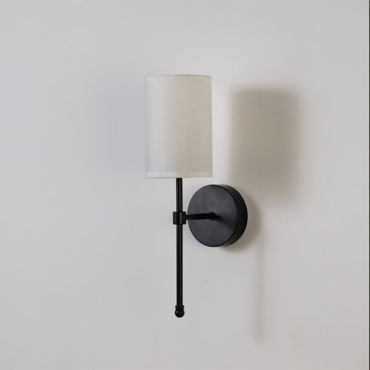 Black metal wall light with white fabric shade on a clean white background with light off highlighting its sleek modern design.