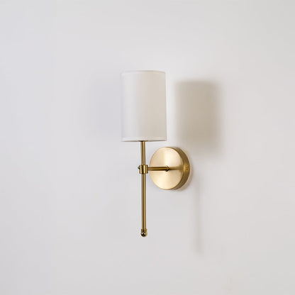 Metal gold wall light with white fabric shade displayed on a white background with light off highlighting its sleek modern wall design.