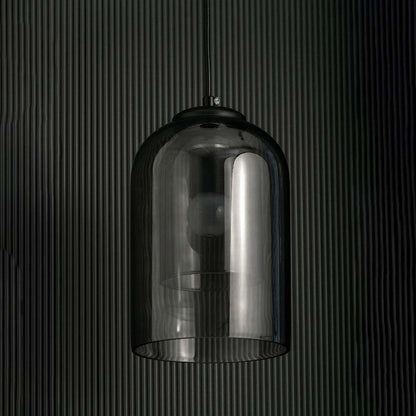 A smoked glass dome pendant light shown with lights off against a dark background emphasizing its glossy curved silhouette and modern aesthetic.