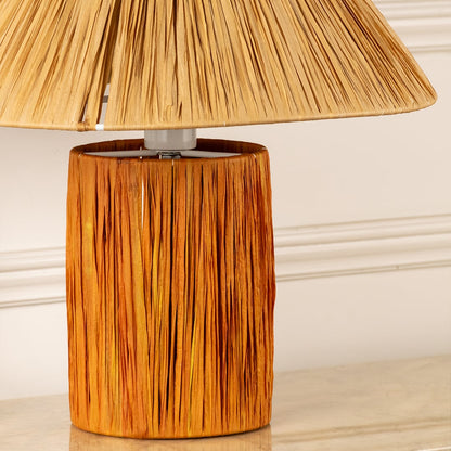 Woven natural fiber lamp shade with handcrafted wooden base highlighting rich texture and artisan craftsmanship.