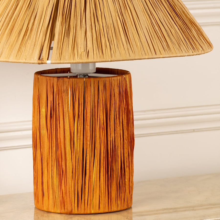Woven natural fiber lamp shade with handcrafted wooden base highlighting rich texture and artisan craftsmanship.