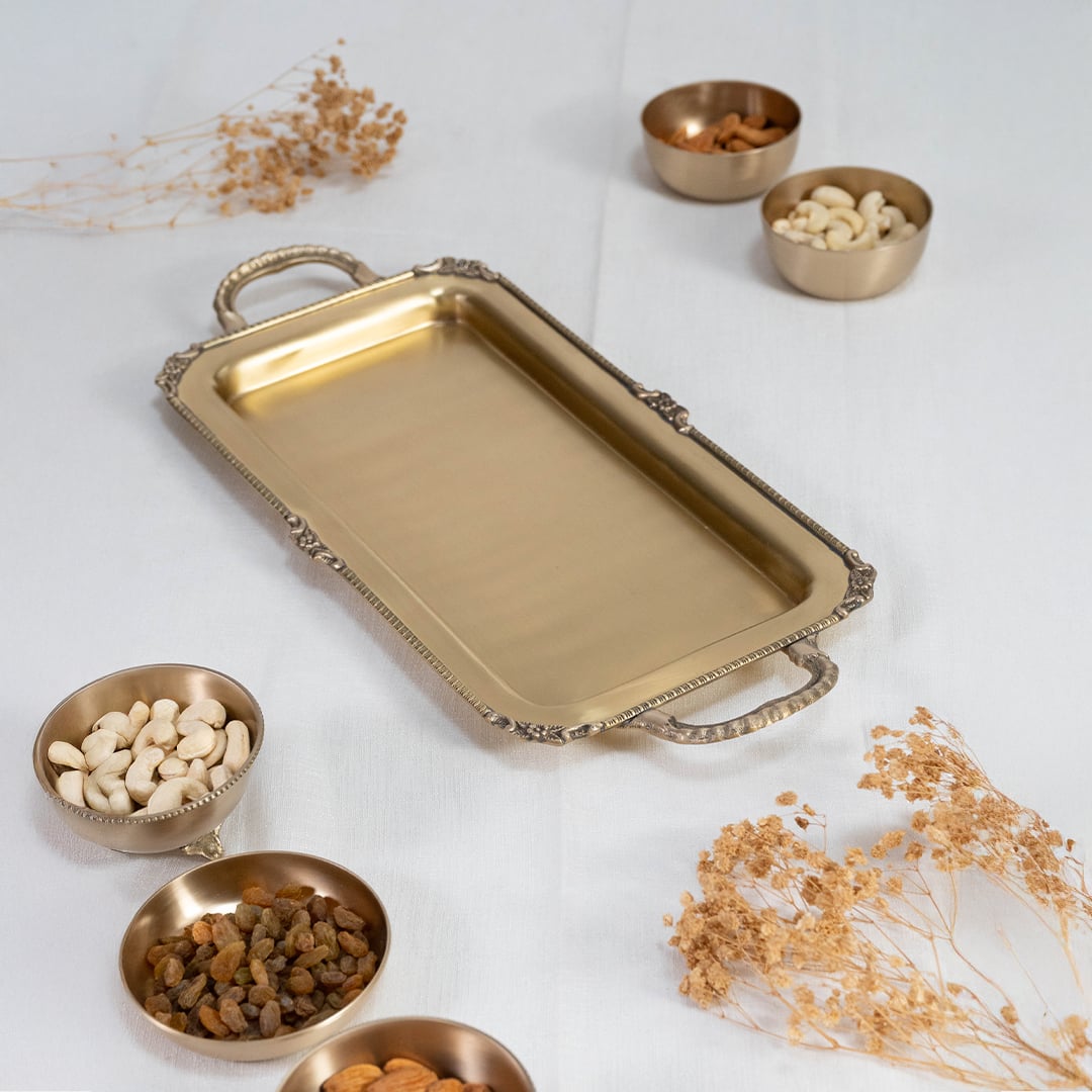Gold metal serving tray neatly placed inside a black gift box with the lid partially open for packaging view.