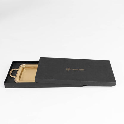Gold metal tray in black branded packaging box with lid open on a white background for gifting presentation.