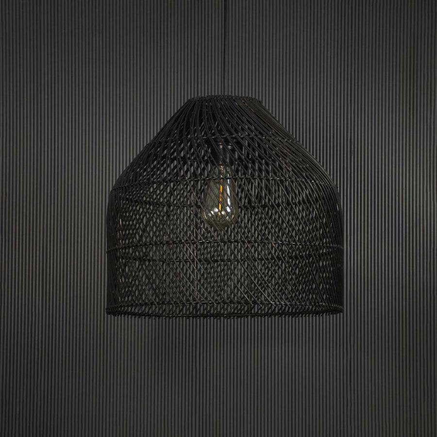 Stylish black rattan pendant lamp against black background highlighting natural weave and sophisticated curved silhouette.