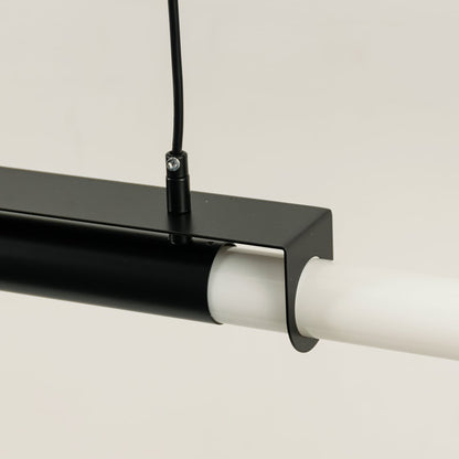 Detailed closeup of black pendant light showing metal frame and smooth white light bar for contemporary decor focus.