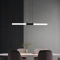 Black linear pendant light with white acrylic tube and modern metal frame styled in a contemporary room for elegant ceiling lighting.