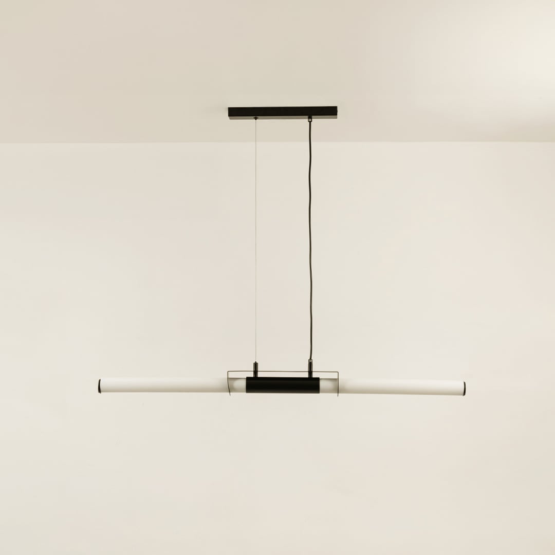 Black pendant light with white acrylic tube displayed off on white background showing clean modern ceiling design.