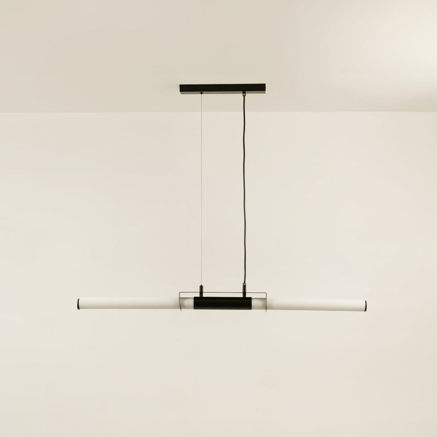 Black pendant light with white acrylic tube displayed off on white background showing clean modern ceiling design.