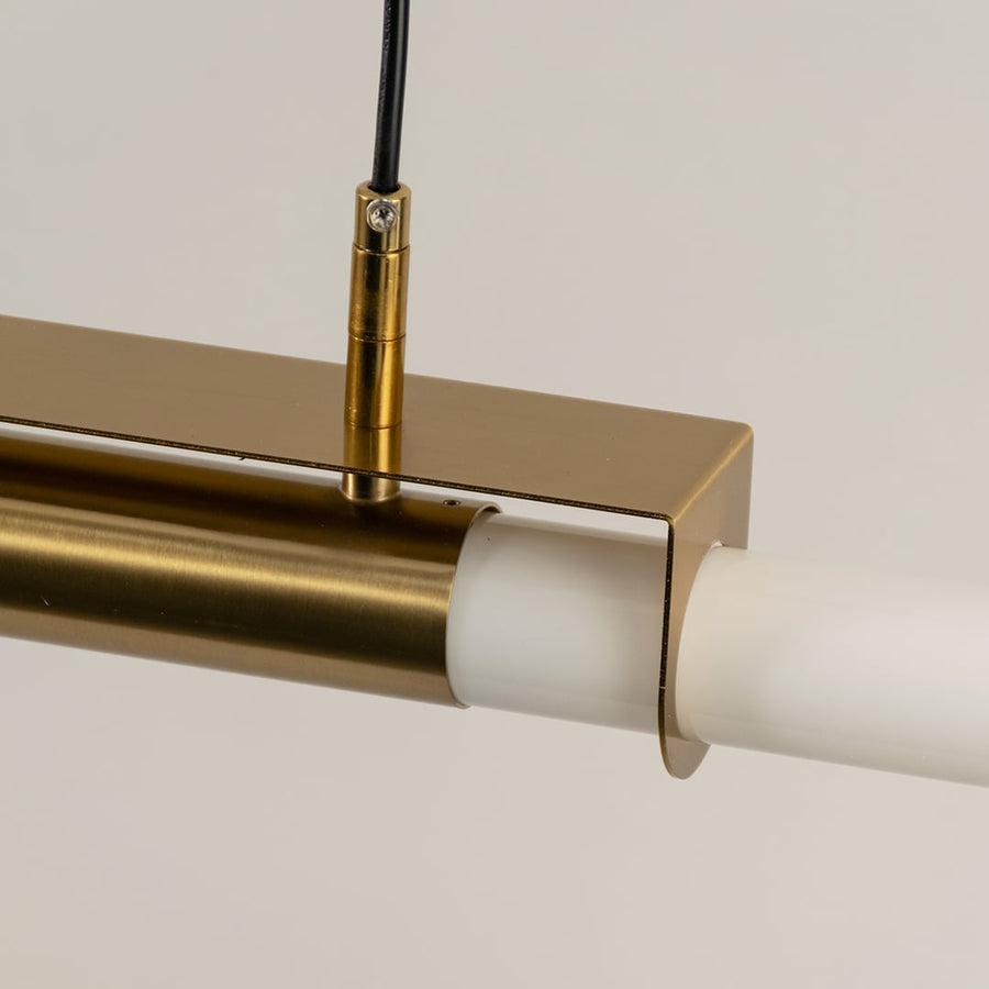Gold metal linear LED pendant light showcasing premium craftsmanship and frosted diffuser detailing for modern interiors.