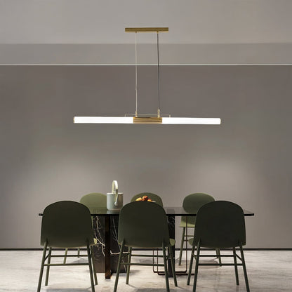 Gold metal linear LED pendant light above dining table creating elegant ambient lighting for modern dining interiors.