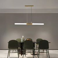 Gold metal linear LED pendant light above dining table creating elegant ambient lighting for modern dining interiors.