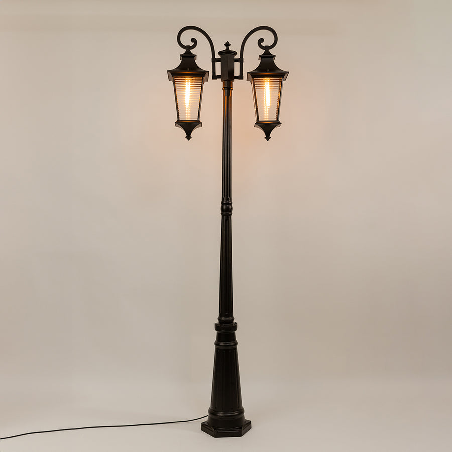 Black outdoor street lamp with dual lantern shades for elegant exterior decor styling use.