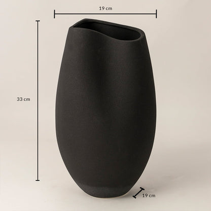 Black ceramic vase measuring 33 cm height and 19 cm width shown on white background with smooth handcrafted finish.