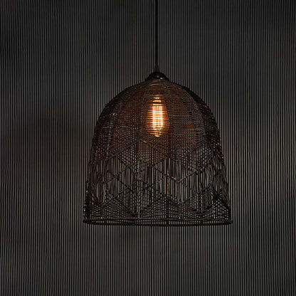 Black woven bamboo pendant lamp glowing softly on white background creating a warm modern ambience.
