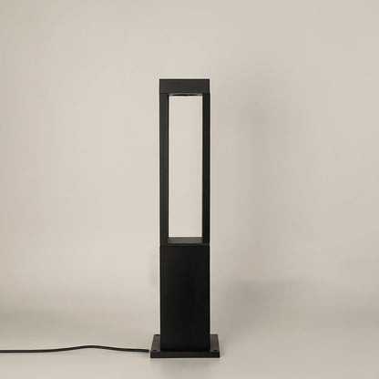 A modern black bollard light shown on a white background with the light off highlighting its open rectangular frame clean lines and sturdy base in a studio setting.