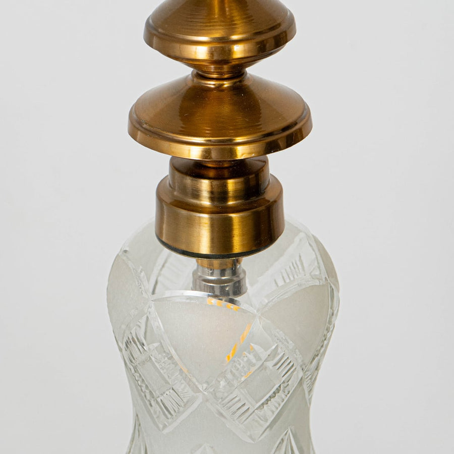 Detailed view of patterned glass and gold metal pendant light showcasing artistic craftsmanship.