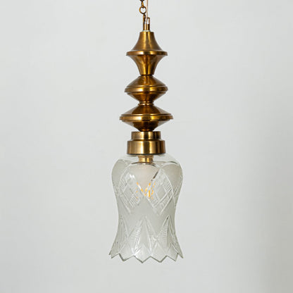 Patterned glass and gold metal pendant light designed for elegant bedroom and dining room interiors.