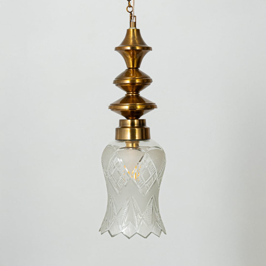 Patterned glass and gold metal pendant light designed for elegant bedroom and dining room interiors.