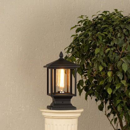 Black metal outdoor post light with ribbed glass Light On placed on a decorative column Lifestyle image patio decor.