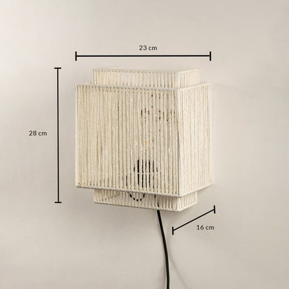 Handwoven jute wall light measuring 28 x 23 x 16 cm combines earthy texture and modern shape ideal for ambient lighting.