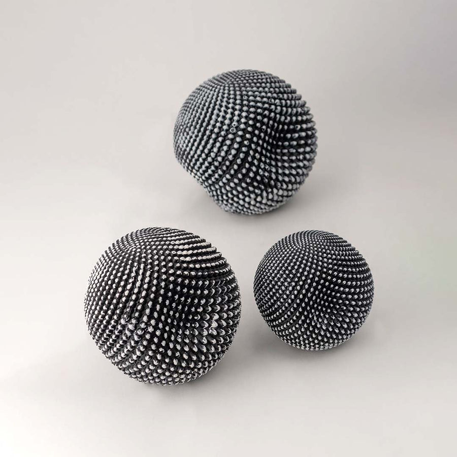 Black textured decorative ball set with woven pattern for modern tabletop styling and minimalist home decor.