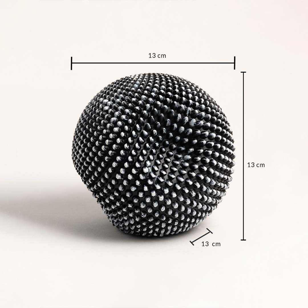 Black and white textured sphere sculpture showing 13 cm dimensions for height width and depth.