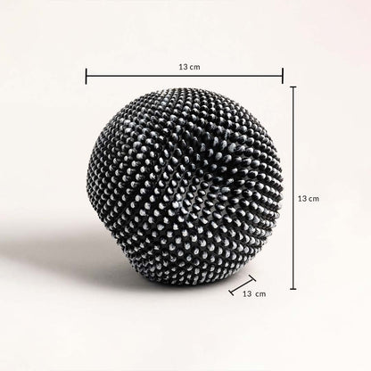 Black and white textured sphere sculpture showing 13 cm dimensions for height width and depth.