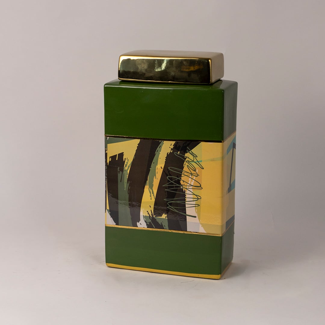 Side angle view of green abstract jar showing smooth glossy surface and artistic paint strokes.