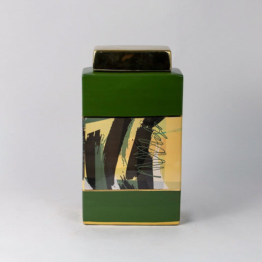 Green abstract jar with golden lid and abstract black and yellow detailing shown on plain white background.