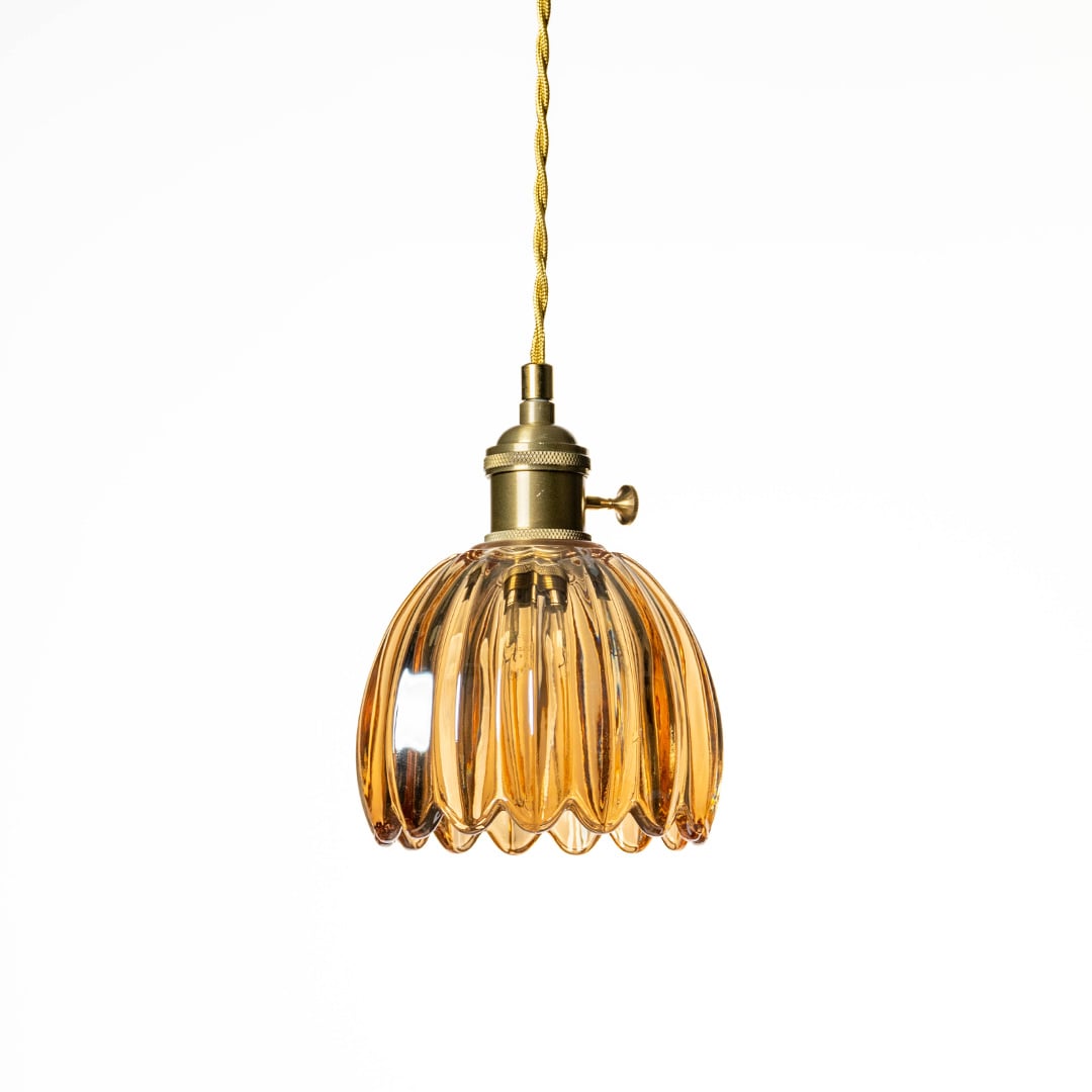 Amber textured glass pendant light with scalloped design crafted for sophisticated modern interiors.